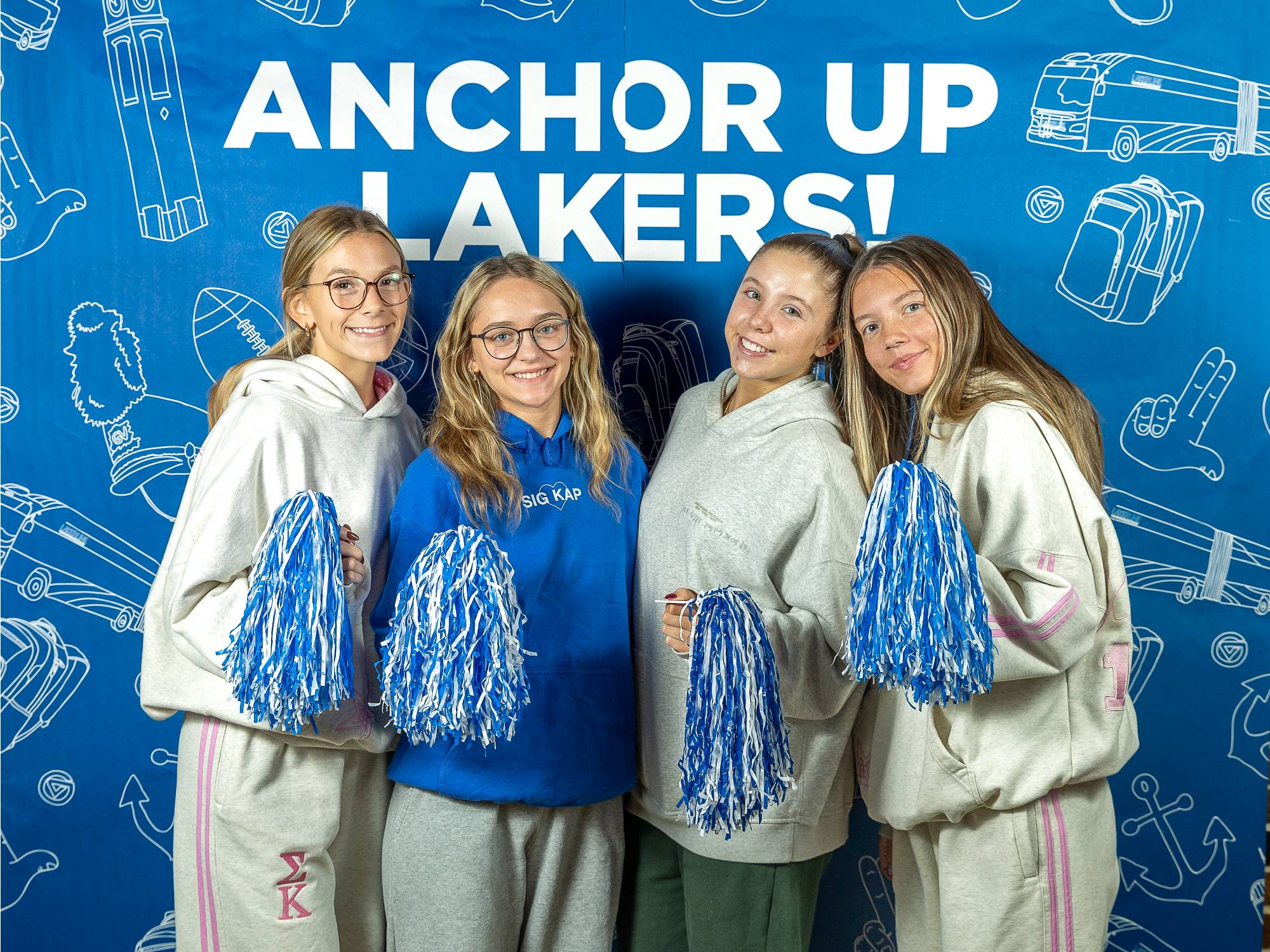 four students pose at GVSU photobooth